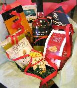 A bottle of red or white wine, premium chocolate, Mississippi cheese straws or other available product, Grab an Olive or other available product, nuts, pourer Drip Stop
